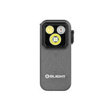 An Olight tactical LED light in a dark gray rugged housing, featuring a black front faceplate with two illuminated yellow lenses and the white Olight logo on the lower front.